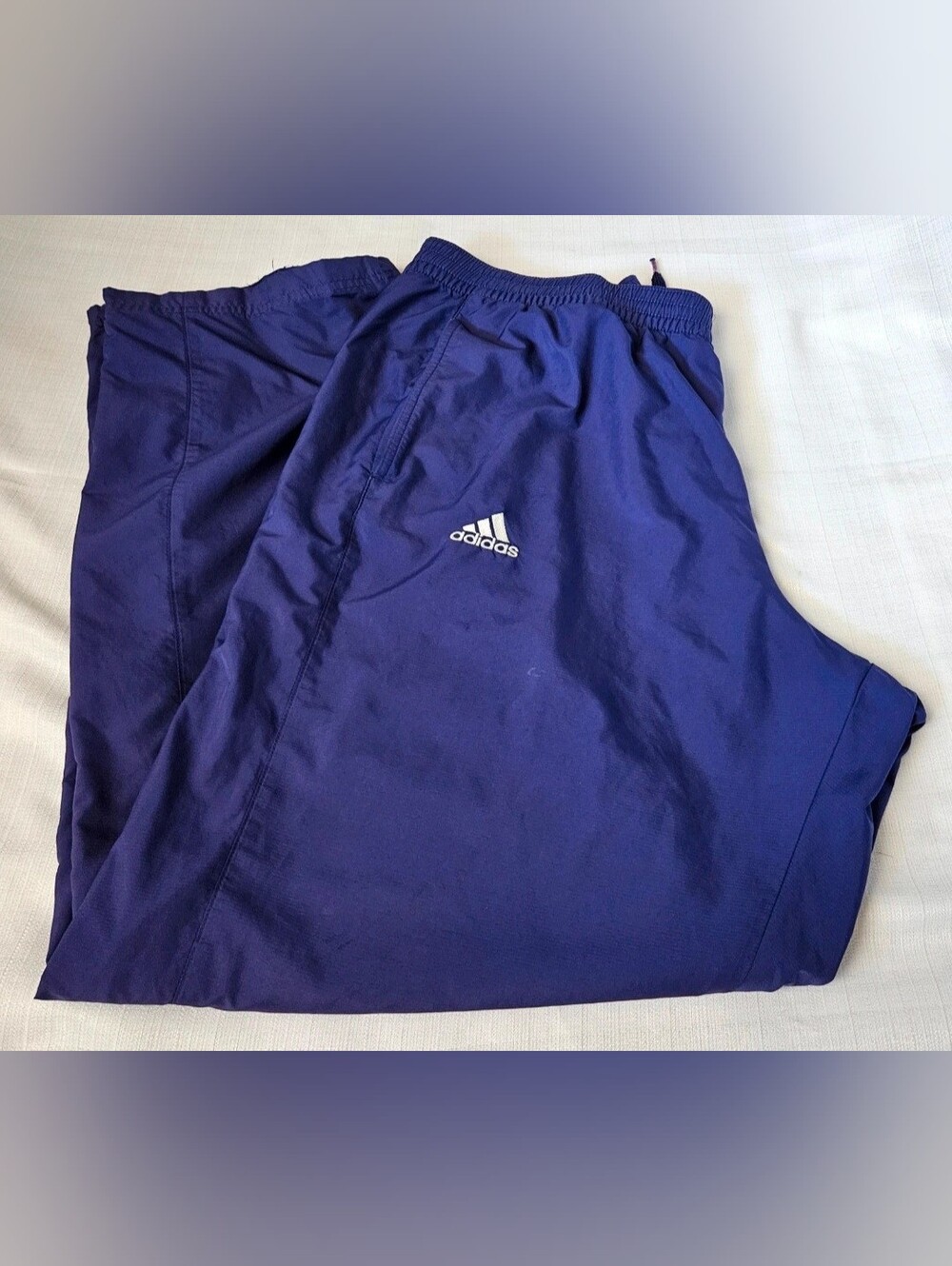 Vintage Y2K Adidas track windbreaker pants in a vibrant royal purple